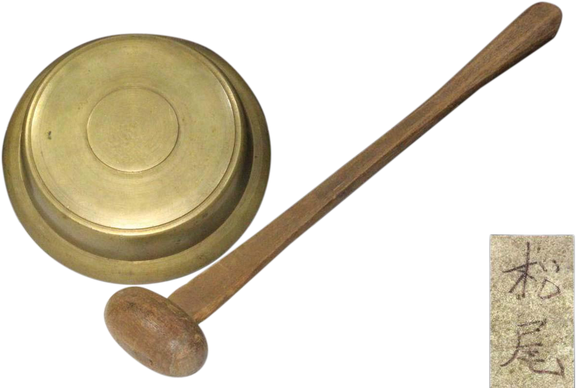 A Brass Bowl And A Wooden Mallet