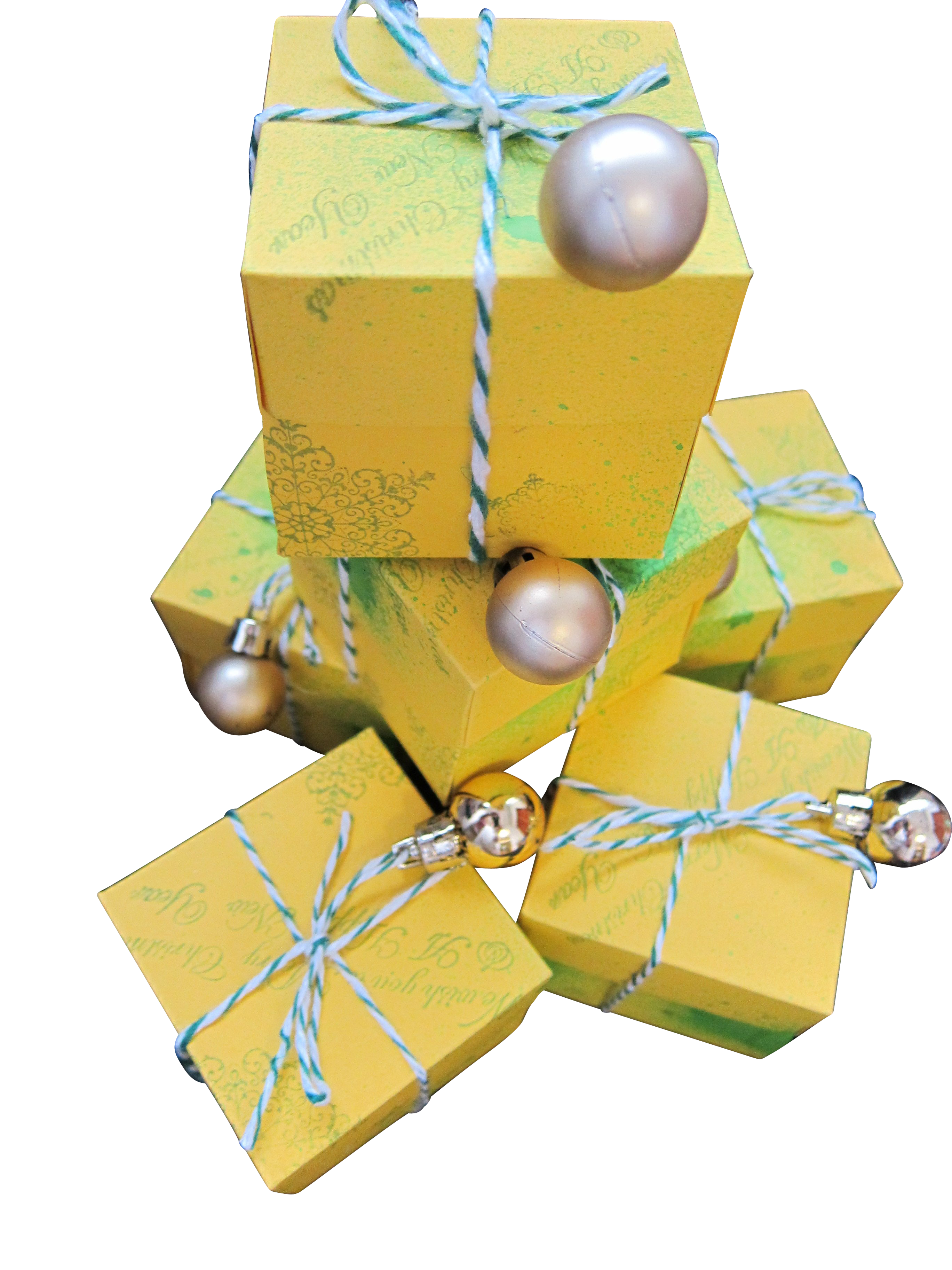 A Stack Of Yellow Boxes With Silver Balls And Blue String