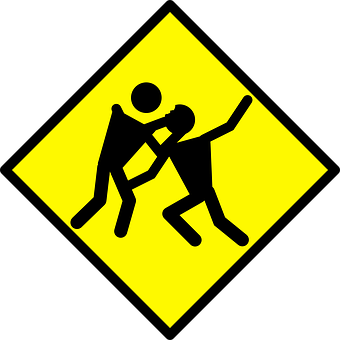A Yellow And Black Sign With A Couple Of People Fighting
