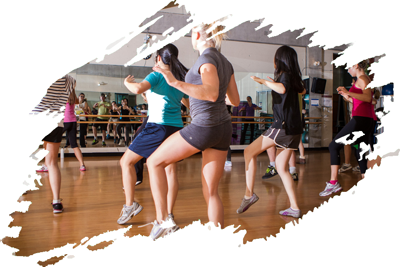 A Group Of People Dancing In A Gym